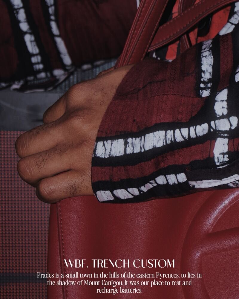 Close detail of a hand on a red and white patterned custom trench